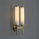 Stylish Art Deco Brass Wall Lamp showcasing frosted glass shades and warm illumination on a wall.