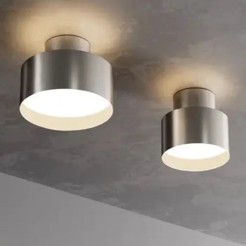 hero Two modern ceiling lamps on a ceiling with a neutral color scheme.
