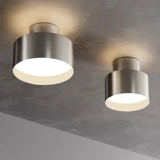 hero Two modern ceiling lamps on a ceiling with a neutral color scheme.
