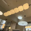 Nordic Art Deco Linear LED Pendant Light – Sculptural Acrylic & Iron Chandelier showcasing elegant acrylic shades in a modern setting.