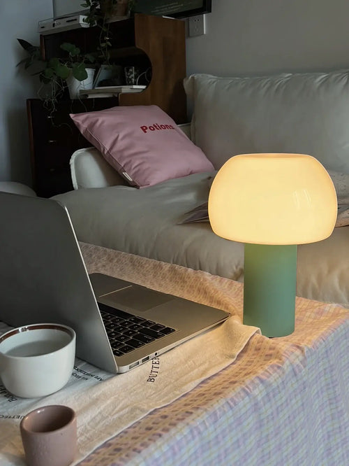Modern Mushroom LED Table Lamp – Rechargeable & Portable Light on bedside table with laptop and cup.