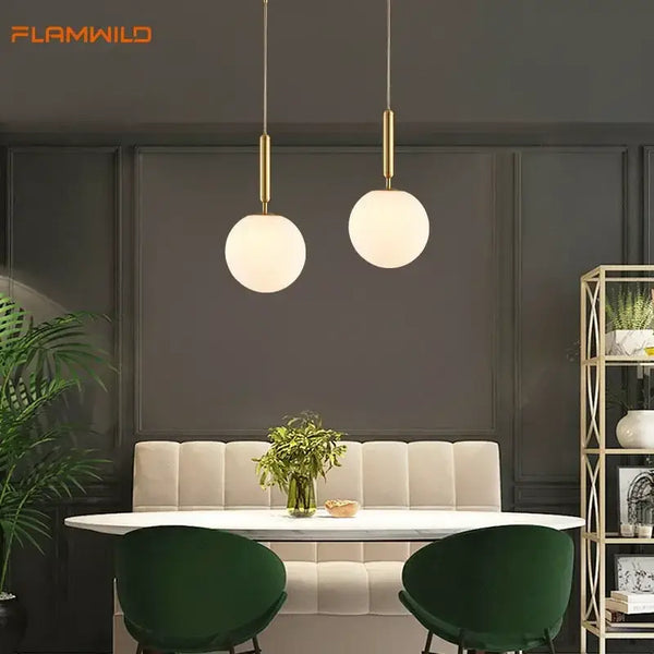 Mid-Century Modern Glass Ball Pendant Light hanging in a dining area with green chairs and stylish decor.