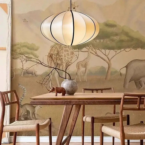 Zen Silk Pendant Light Mid Century Fabric Lantern illuminating a dining area with animal-themed mural background.