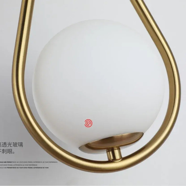 Drop Luxury Glass Ball Wall lamp featuring a sleek white glass ball and elegant gold metalwork.