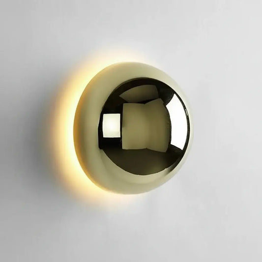 HERO Gold spherical wall light fixture on a gray background