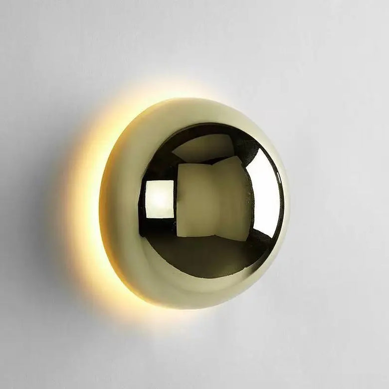HERO Gold spherical wall light fixture on a gray background