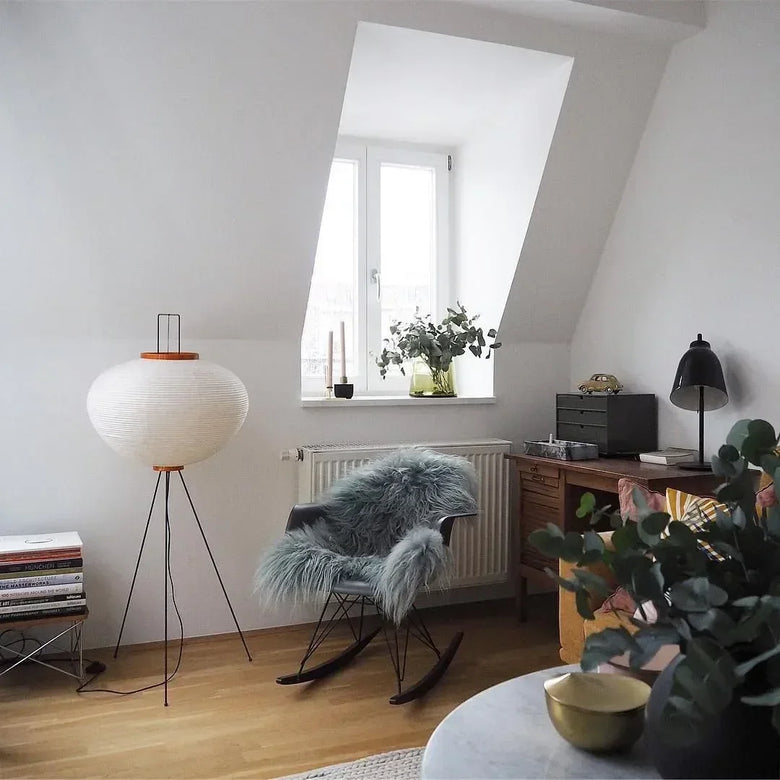 Modern living room with a rocking chair, lamp, and plants. Japanese Rice Paper Lamp.
