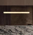 Natural Marble Linear Pendant Light 80–120cm hanging elegantly above a marble countertop.