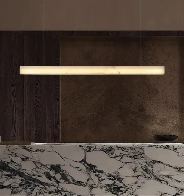 Natural Marble Linear Pendant Light 80–120cm hanging elegantly above a marble countertop.