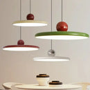 Modern Minimalist Pendant Lamp – Elegant Bedside & Dining Room Lighting in cream, red, and green hanging above a table.