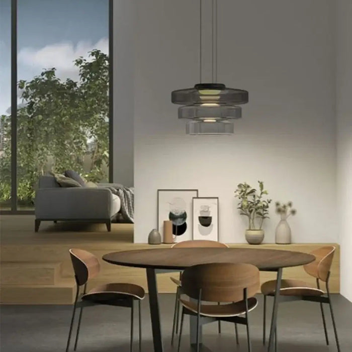 Layered Glass Pendant Light – Modern Amber, Green or Smoke Grey LED Suspension illuminating a stylish dining area.