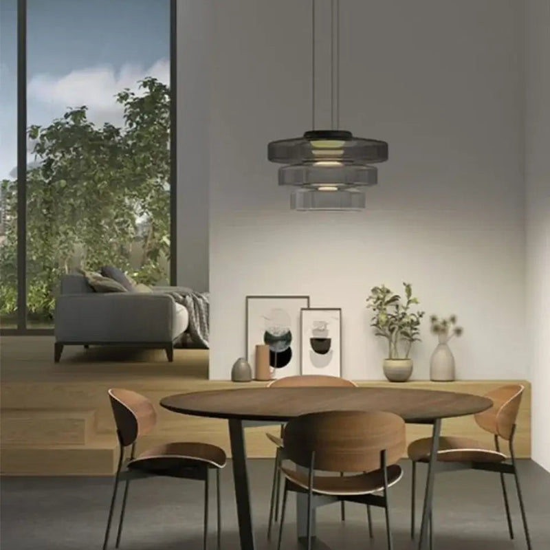 Layered Glass Pendant Light – Modern Amber, Green or Smoke Grey LED Suspension illuminating a stylish dining area.