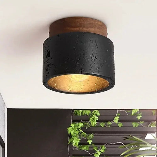 Black Travertine Ceiling Lamp showcasing a modern design with natural stone and a warm glow.