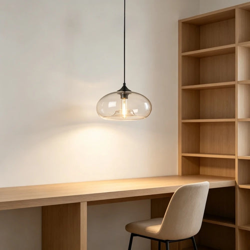 Clear glass dome pendant light over a wooden desk and bookshelf
