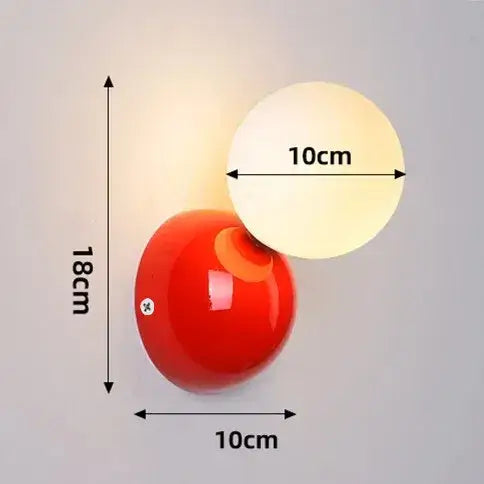 70s revival wall lamp in 3 different colours with red painted metal base and frosted glass ball, measuring 18cm x 10cm.