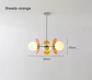 Rare Mid-Century Orange Plexiglass Chandelier: A Unique Vintage Gem with orange reflectors and white glass balls.