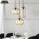 Grey Frosted Sphere Glass Hanging Lamp in modern dining setting, showcasing grey frosted shades and stylish design.