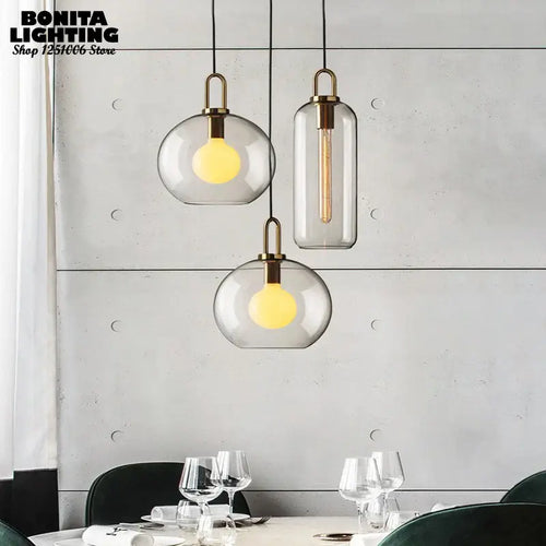 Grey Frosted Sphere Glass Hanging Lamp in modern dining setting, showcasing grey frosted shades and stylish design.