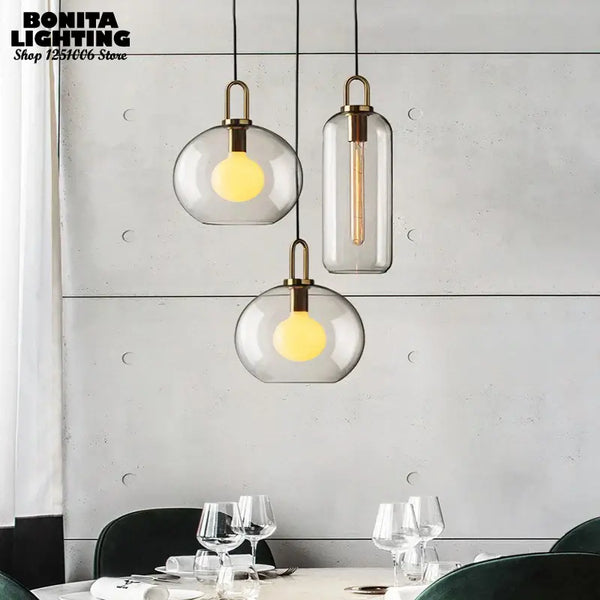 Grey Frosted Sphere Glass Hanging Lamp in modern dining setting, showcasing grey frosted shades and stylish design.
