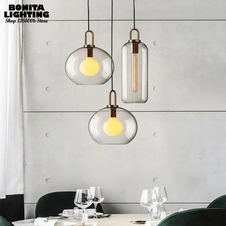 Grey Frosted Sphere Glass Hanging Lamp in modern dining setting, showcasing grey frosted shades and stylish design.