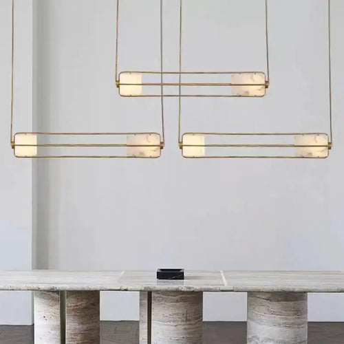 Elegant White Glass & Metal Art Deco Chandelier hanging above a stylish table in a modern setting.