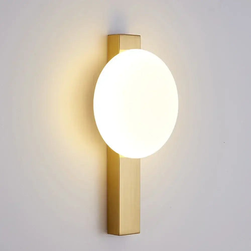 Minimalist Nordic Wall Lamp with Frosted White Ball on a gold rectangular base, enhancing modern aesthetic.