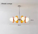 Rare Mid-Century Orange Plexiglass Chandelier: A Unique Vintage Gem with orange reflectors and white frosted glass balls.