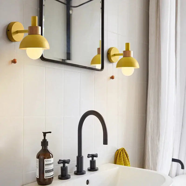 Pull Chain Nordic Sconce lighting in a modern bathroom featuring stylish gold sconces and a black faucet.