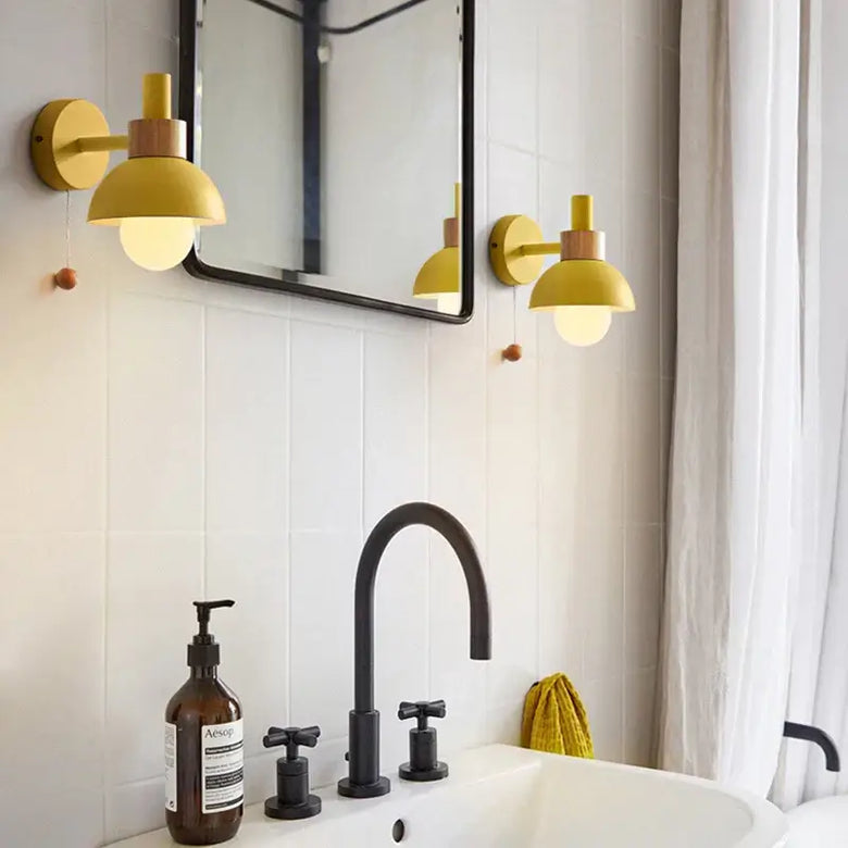 Pull Chain Nordic Sconce lighting in a modern bathroom featuring stylish gold sconces and a black faucet.