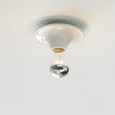 80s revival wall light with UFO-shaped base and silver top bulb, perfect for adding retro charm to modern interiors.