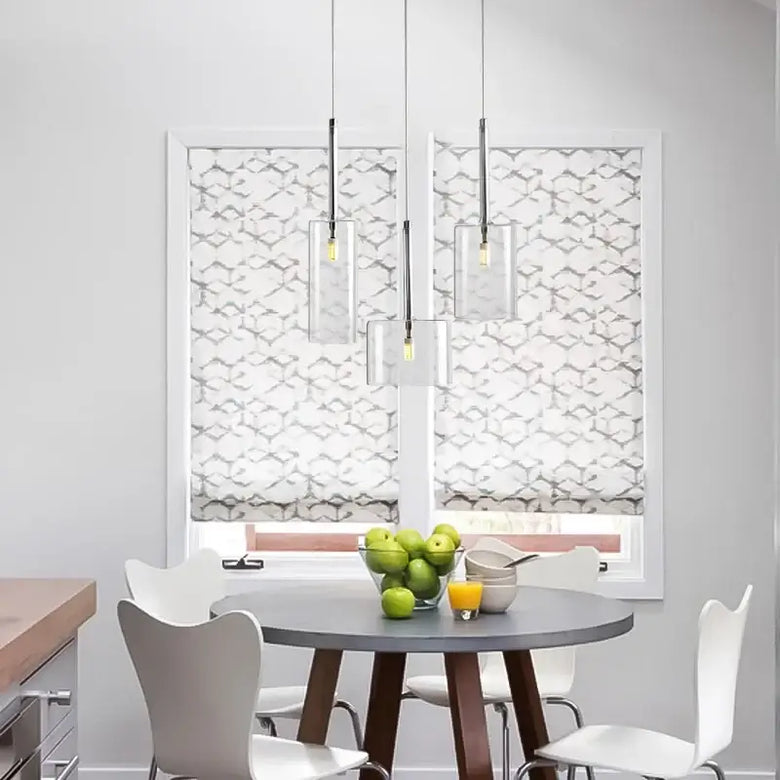 Neo Transparent Scandinavian Light Fixture hangs above a modern kitchen table with fresh fruit and juice.