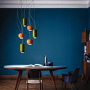Modern Glass Pendant Light – Italian-Inspired LED Suspension Lamp in green and orange colors above a dining table.