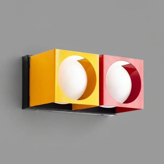 hero Modern wall light fixture with yellow and red accents on a white background