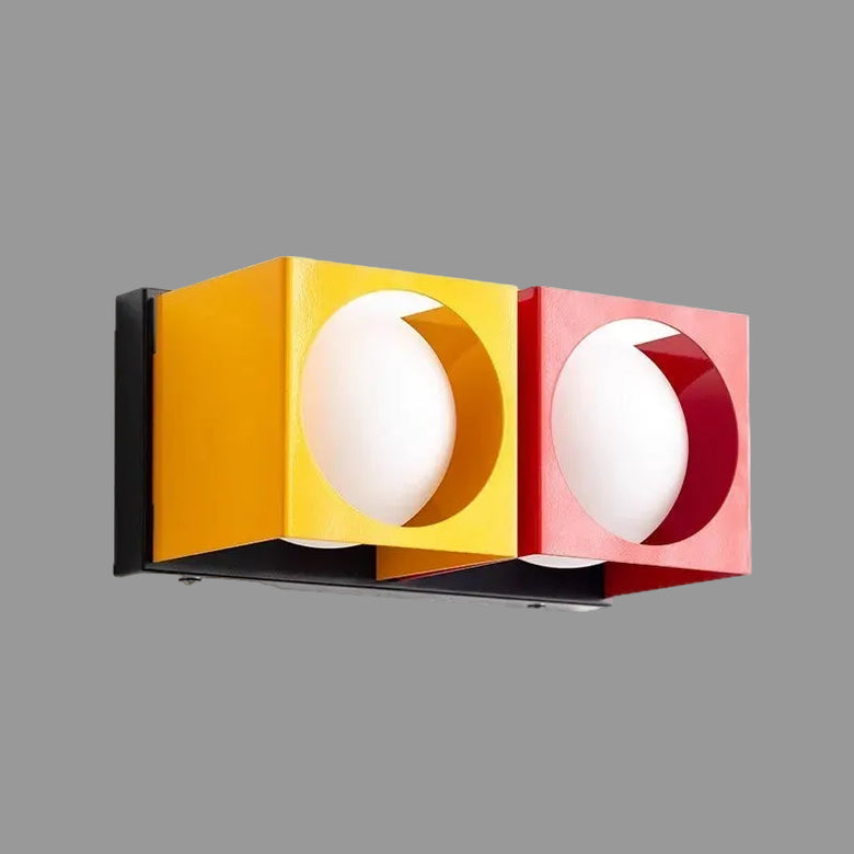 hero Modern wall light fixture with yellow and red accents on a white background