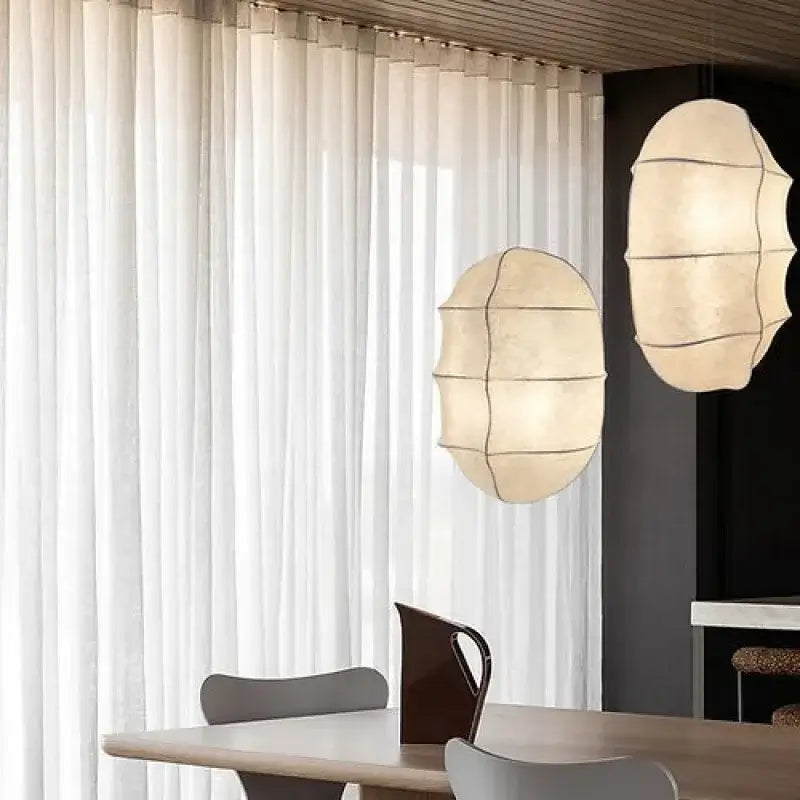 Japanese Wabi-Sabi Silk Pendant Light – Sculptural White Hanging Lamp illuminating a modern dining area.