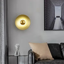 Colourful 30 cm Modern Circle Wall Light with Gold illuminating a chic living room setting.