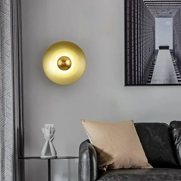 Colourful 30 cm Modern Circle Wall Light with Gold illuminating a chic living room setting.