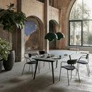 Contemporary Pendant Light illuminating a modern dining area with plants and stylish chairs.