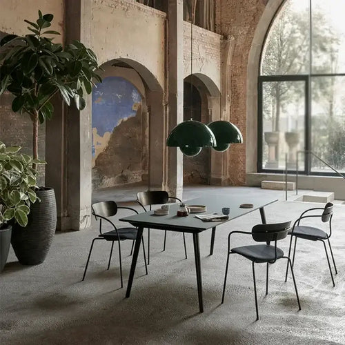 Contemporary Pendant Light illuminating a modern dining area with plants and stylish chairs.