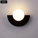 Halfmoon Metal Sconce in black color, stylish LED wall lamp with Nordic design for modern interiors.