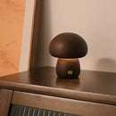 Portable Dimmable 60s Italy Designer Mushroom Table Lamp on a wooden surface, showcasing its warm glow and unique design.