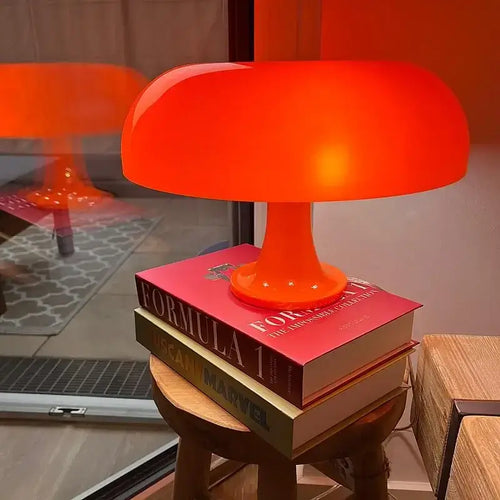 Italian 60s Lamp on stacked books, showcasing modern minimalist design and warm ambient light.