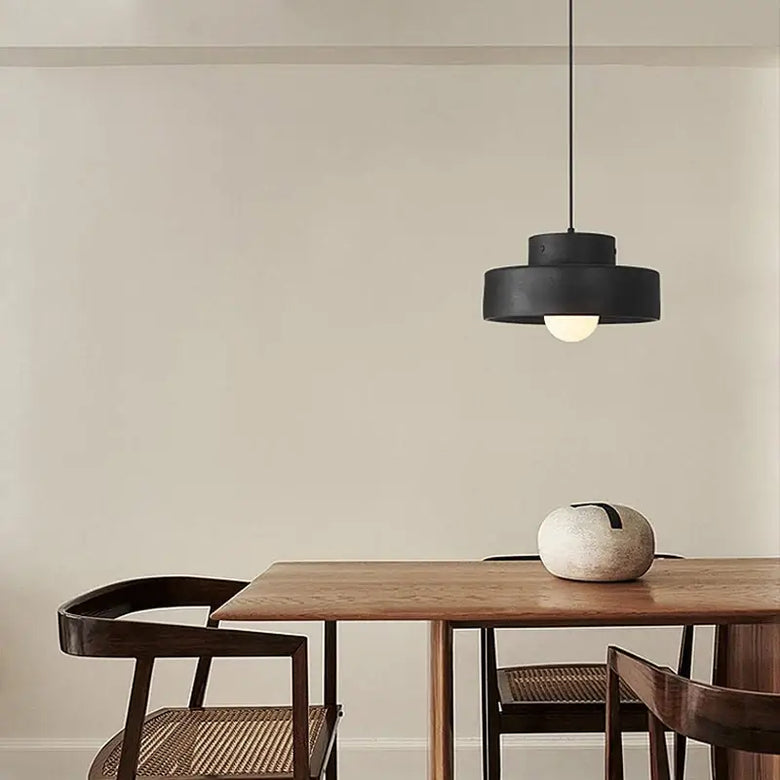 Illuminate Your Space with the Minimalist Nordic Resin Pendant Light hanging above a wooden dining table.