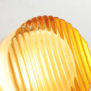 Futuristic and Unique Solid Plexiglass Wall Light in fluted design showcasing captivating amber hue.