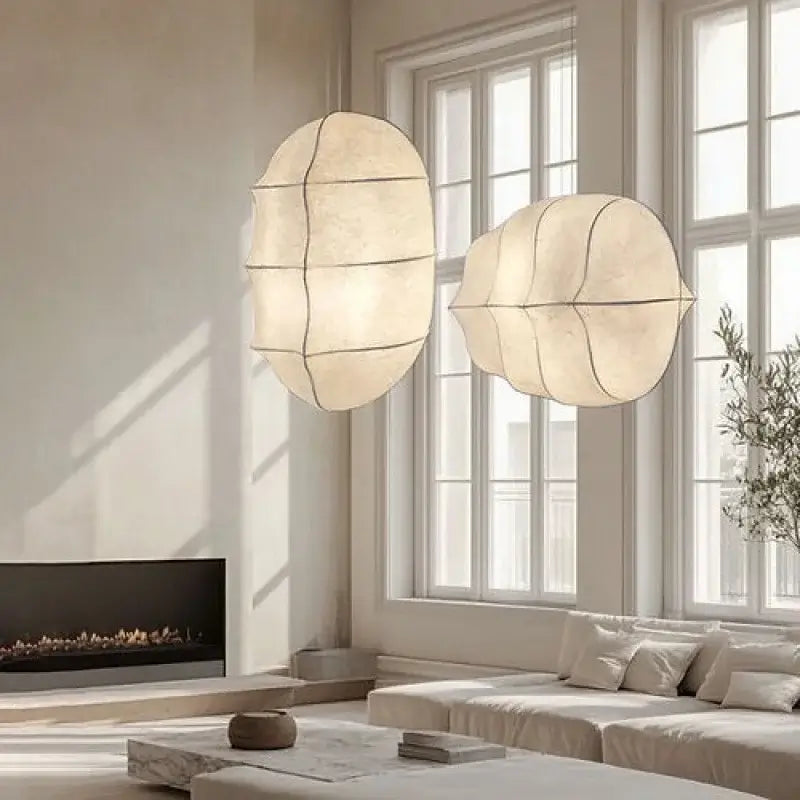 Japanese Wabi-Sabi Silk Pendant Light – Sculptural White Hanging Lamp illuminating a serene living room.