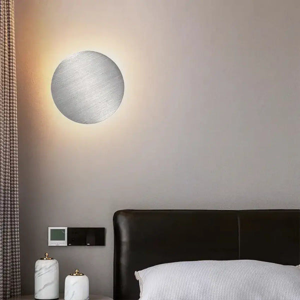 Wall Lamp: Modern Copper Round illuminating a cozy bedroom with elegant design on the wall.