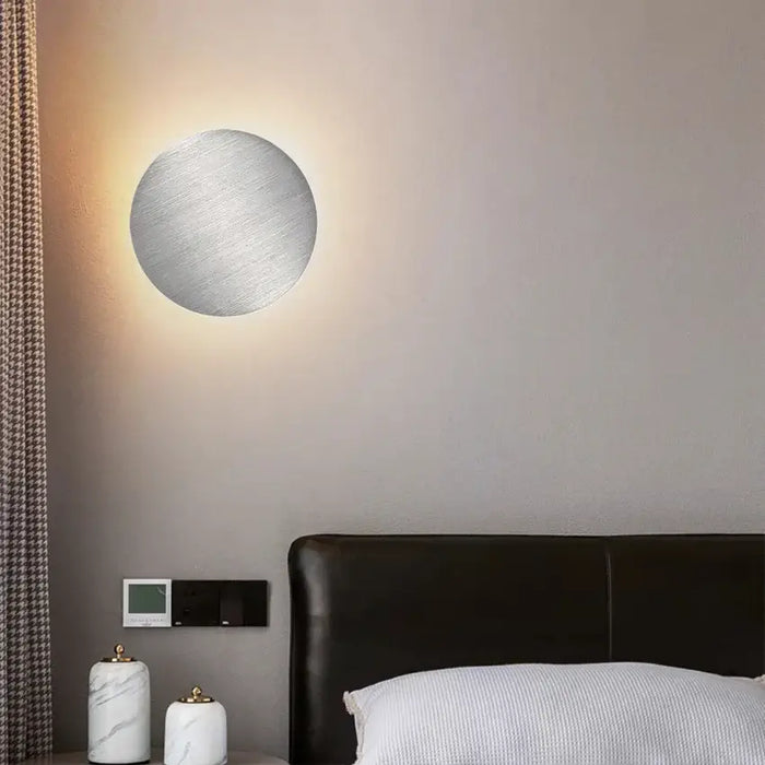 Wall Lamp: Modern Copper Round illuminating a cozy bedroom with elegant design on the wall.