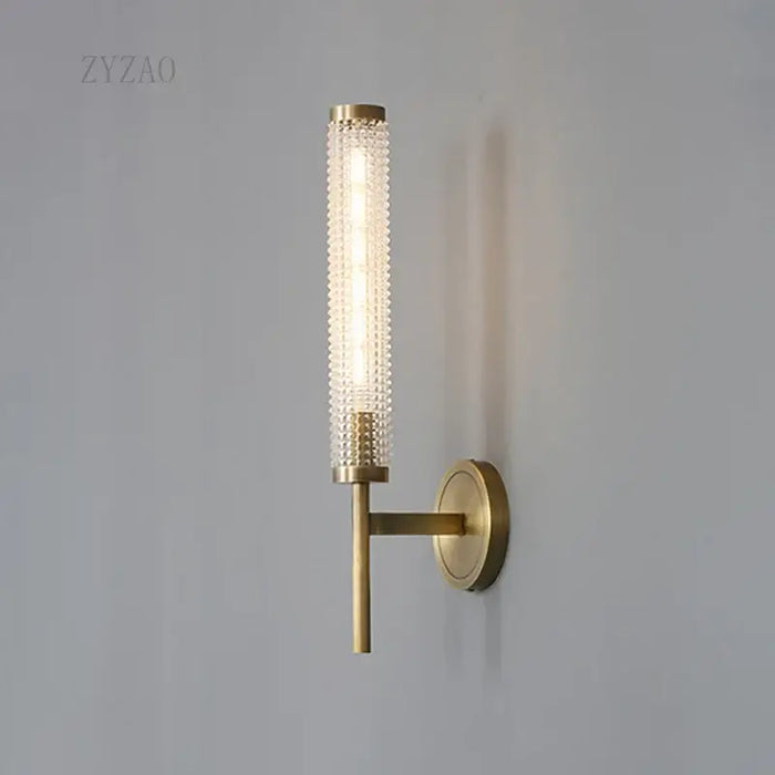 Stylish Art Deco Brass Wall Lamp with frosted glass and warm illumination on a wall.
