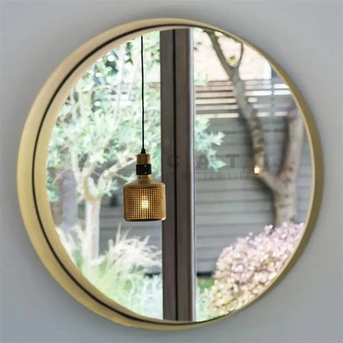 Elegant Radiance: The Gold LED Wall Lamp – Where Style Meets Function reflected in a round mirror.