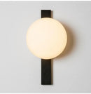 Decorative Lighting Fixture With Milk White Glass Sphere mounted on a wall, featuring a sleek black finish.